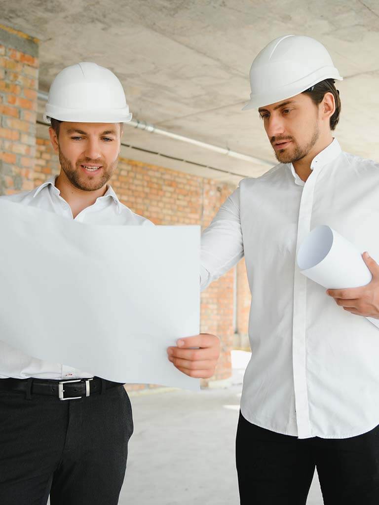 Two contractors review blueprints